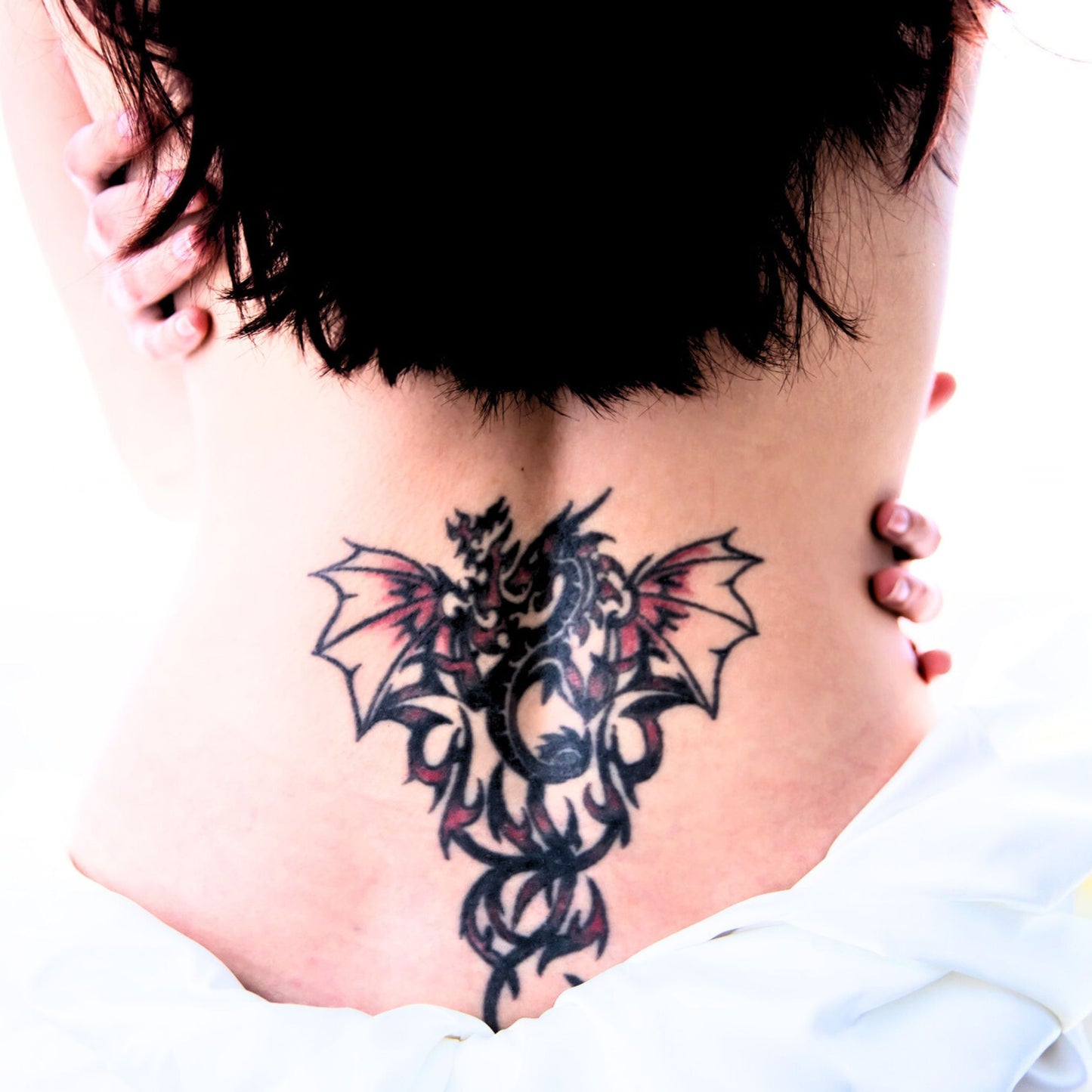 Farmbody woman with botanical tattoo salve on her lower back tattoo for new tattoo aftercare