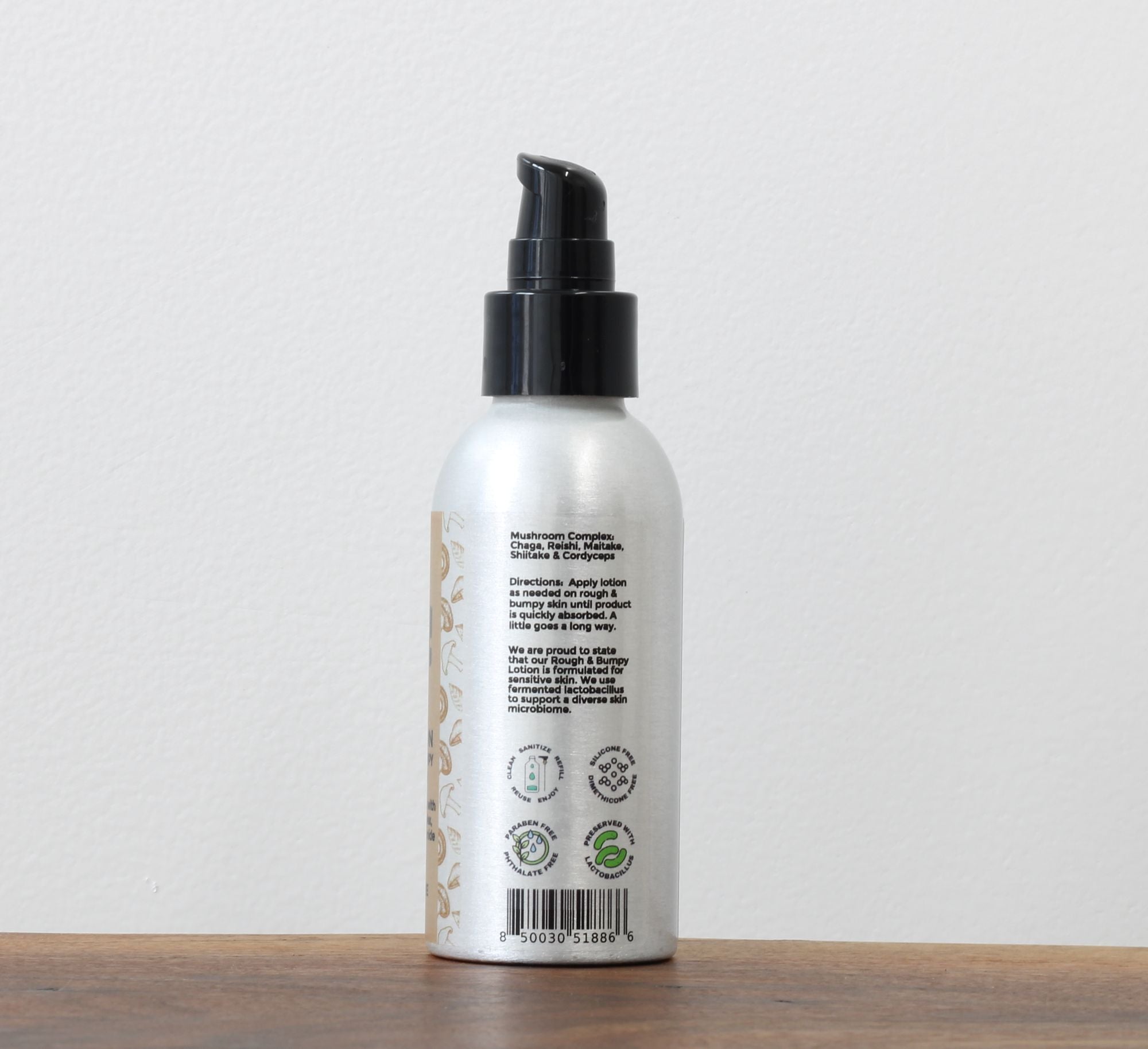 Farmbody AHA Lotion for rough and bumpy skin directions how to use lotion to smooth rough and bumpy skin with niacinnamide and mushroom skin care ingredients showing a refillable sustainable aluminum bottle for AHA Rough and Bumpy Skin Lotion
