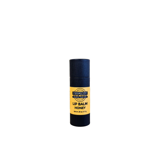 Lip balm with black and yellow biodegradable packaging on a white background