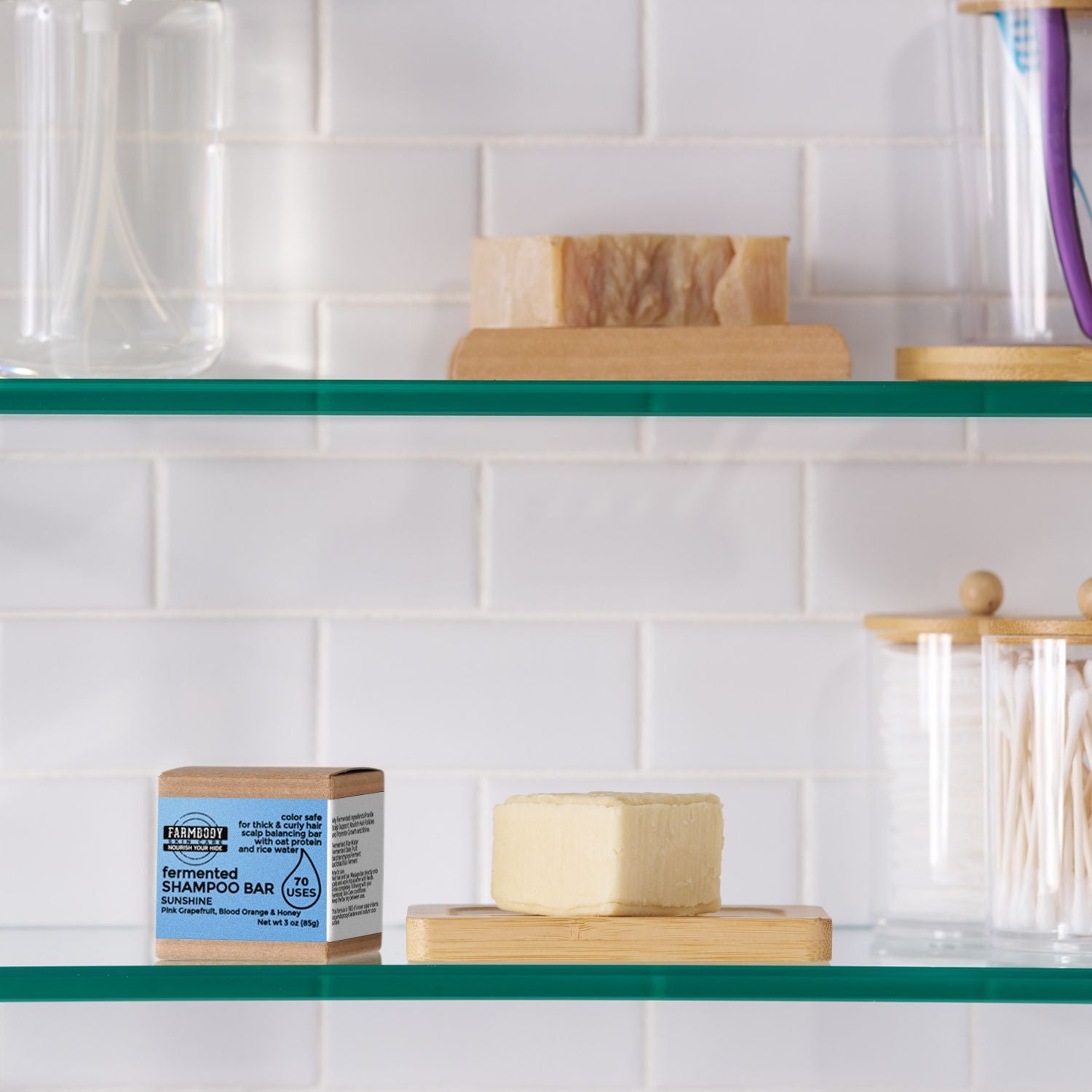 solid fermented rice water shampoo bar for thick and curly hair on a shelf in a shower in a citrus scent